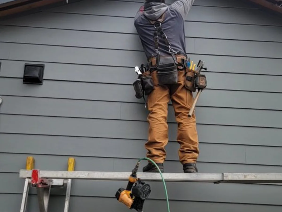 Hunter Exteriors crew installing fascia details on a Vernon home